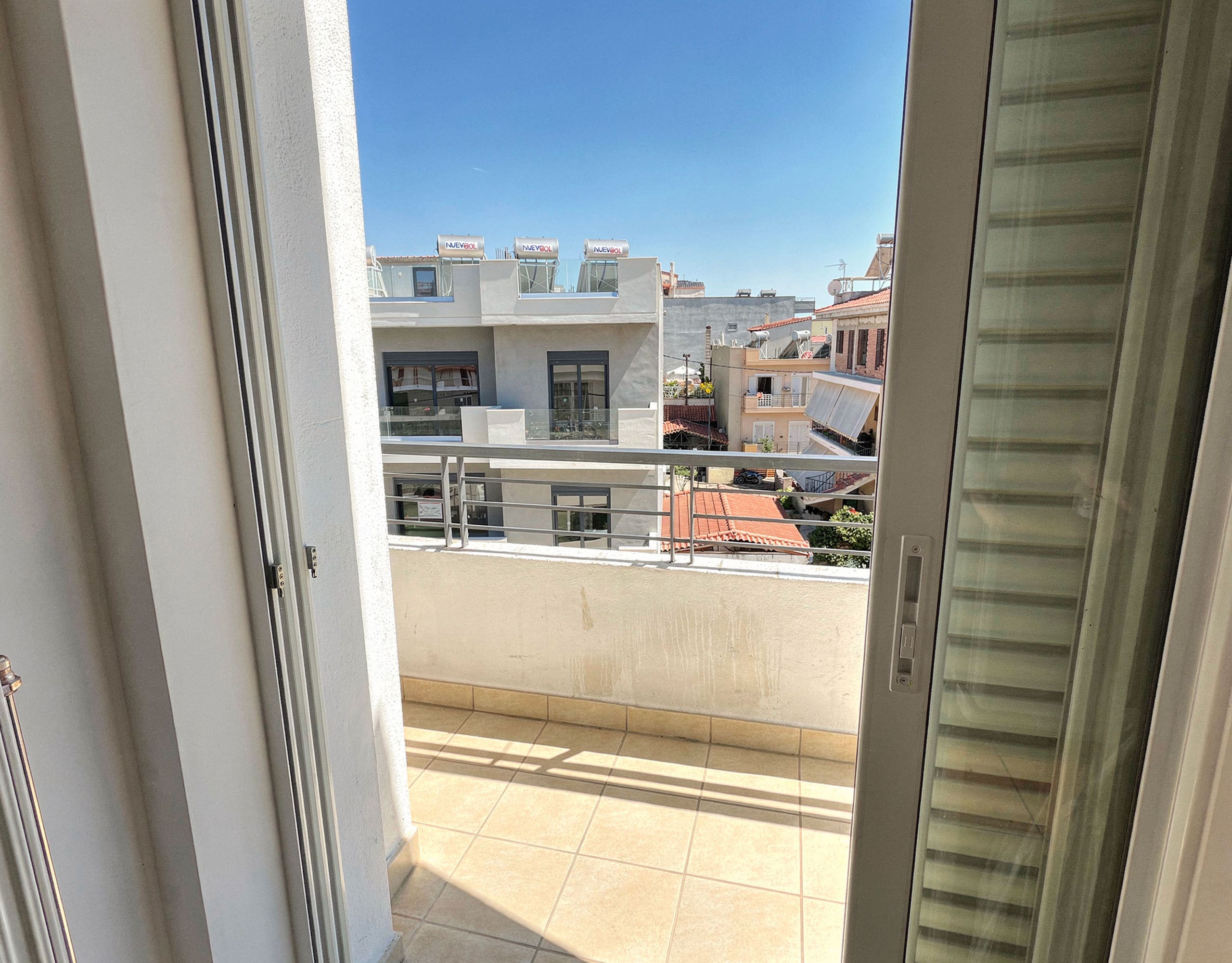 Balcony doorway view with outdoor space and city surroundings, Vasiliko, Evia, Greece