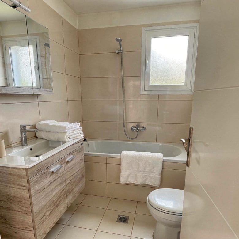 Bathroom with vanity, toilet, and tiled walls, Vasiliko, Evia, Greece
