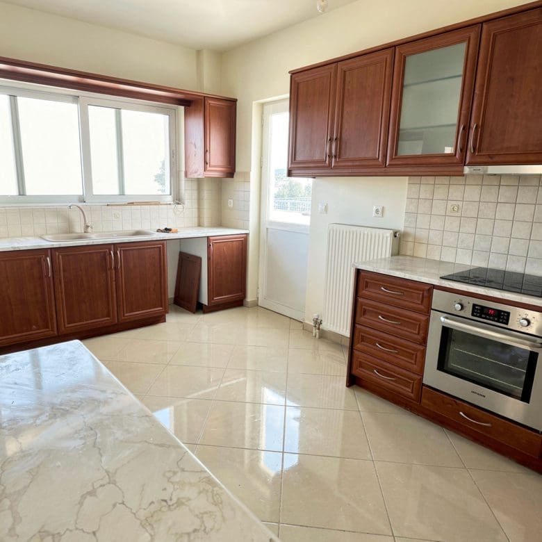 Kitchen with wooden cabinets, built-in oven, and tiled floor, Vasiliko, Evia, Greece