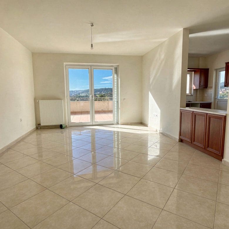 Bright open-plan living area with tiled floor and balcony doors, Vasiliko, Evia, Greece