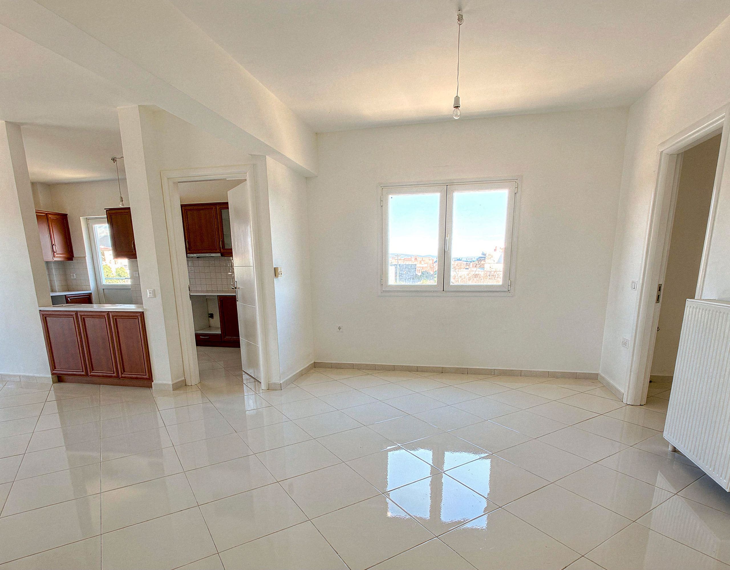 Open-plan interior with tiled floor and kitchen connection, Vasiliko, Evia, Greece
