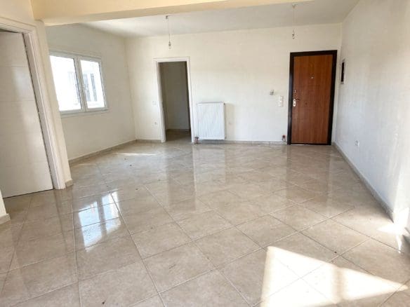 Spacious empty living room with tiled floor and entry door, Vasiliko, Evia, Greece