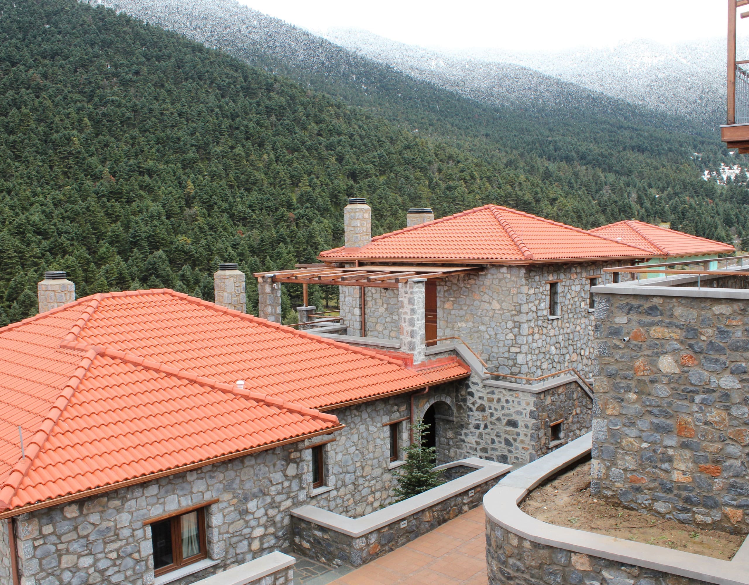 Panoramic view over stone rooftops and green mountain slopes, Kardaras, Mount Mainalo, Arcadia, Greece