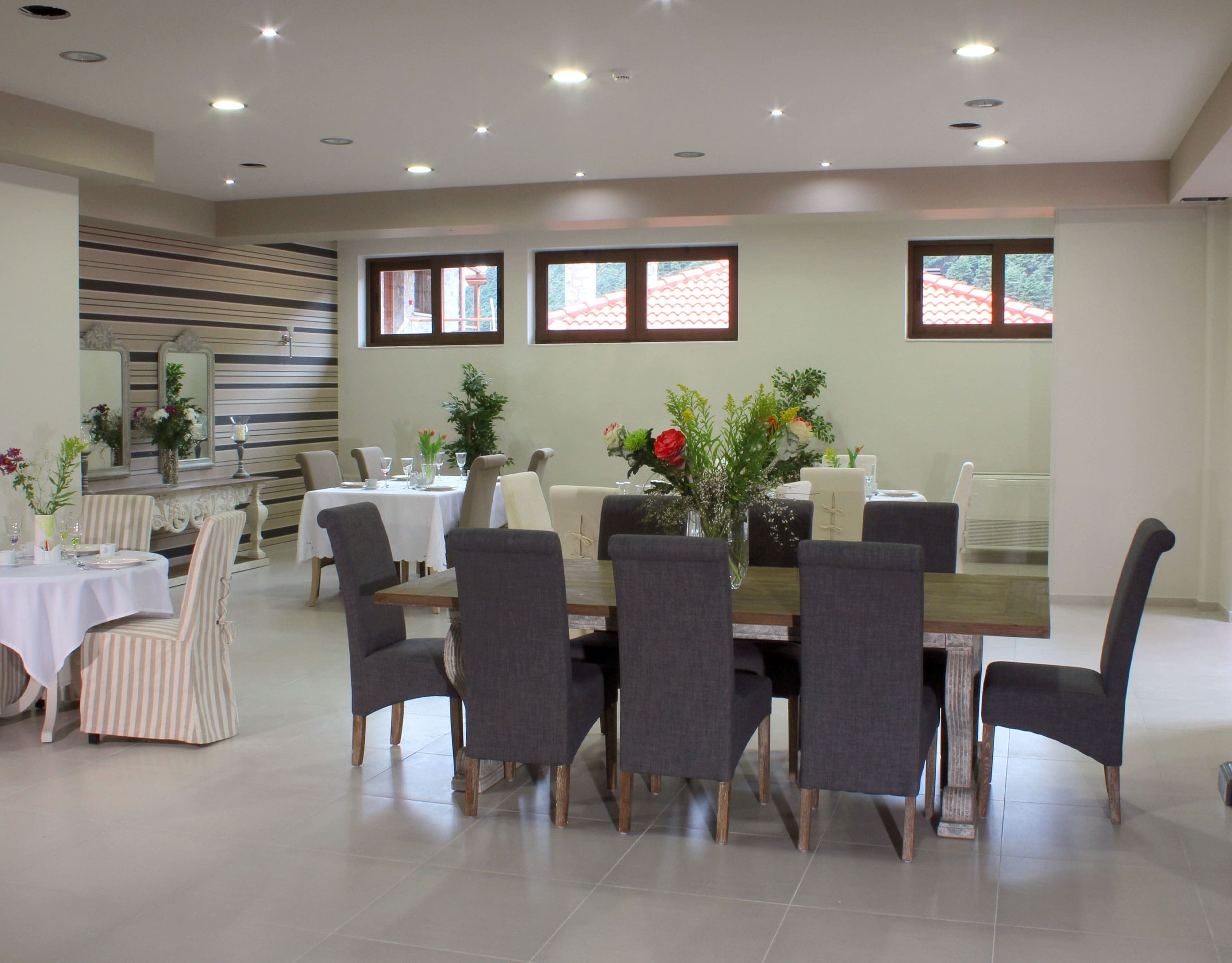 Dining room with long table, chairs, and bright interior lighting, Kardaras, Mount Mainalo, Arcadia, Greece