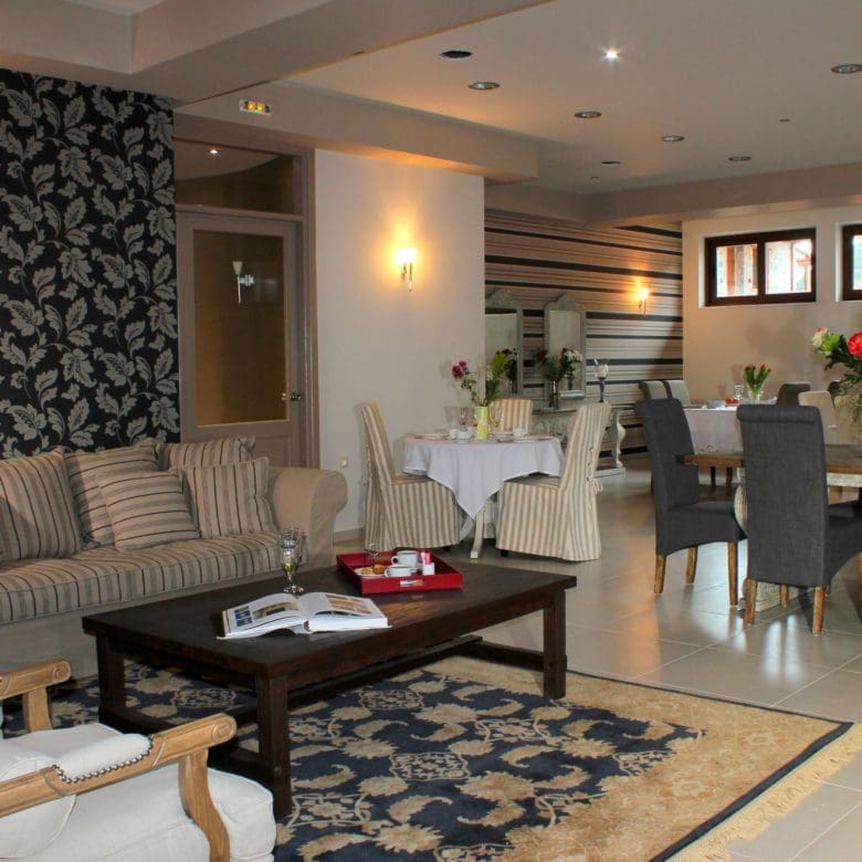 Open-plan lounge and dining area with classic seating and patterned decor, Kardaras, Mount Mainalo, Arcadia, Greece