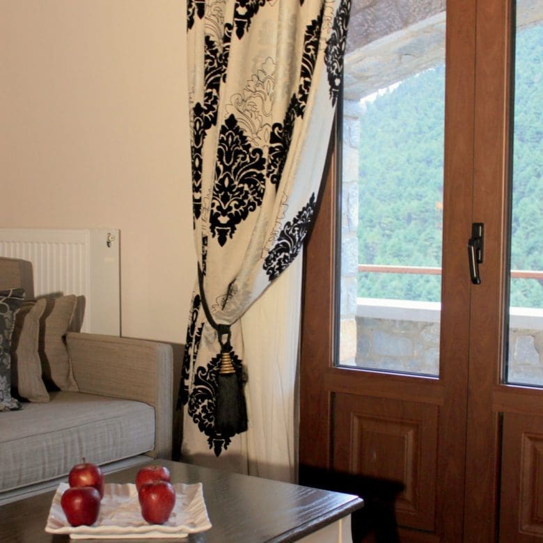 Living room corner with sofa seating and balcony door with mountain view, Kardaras, Mount Mainalo, Arcadia, Greece