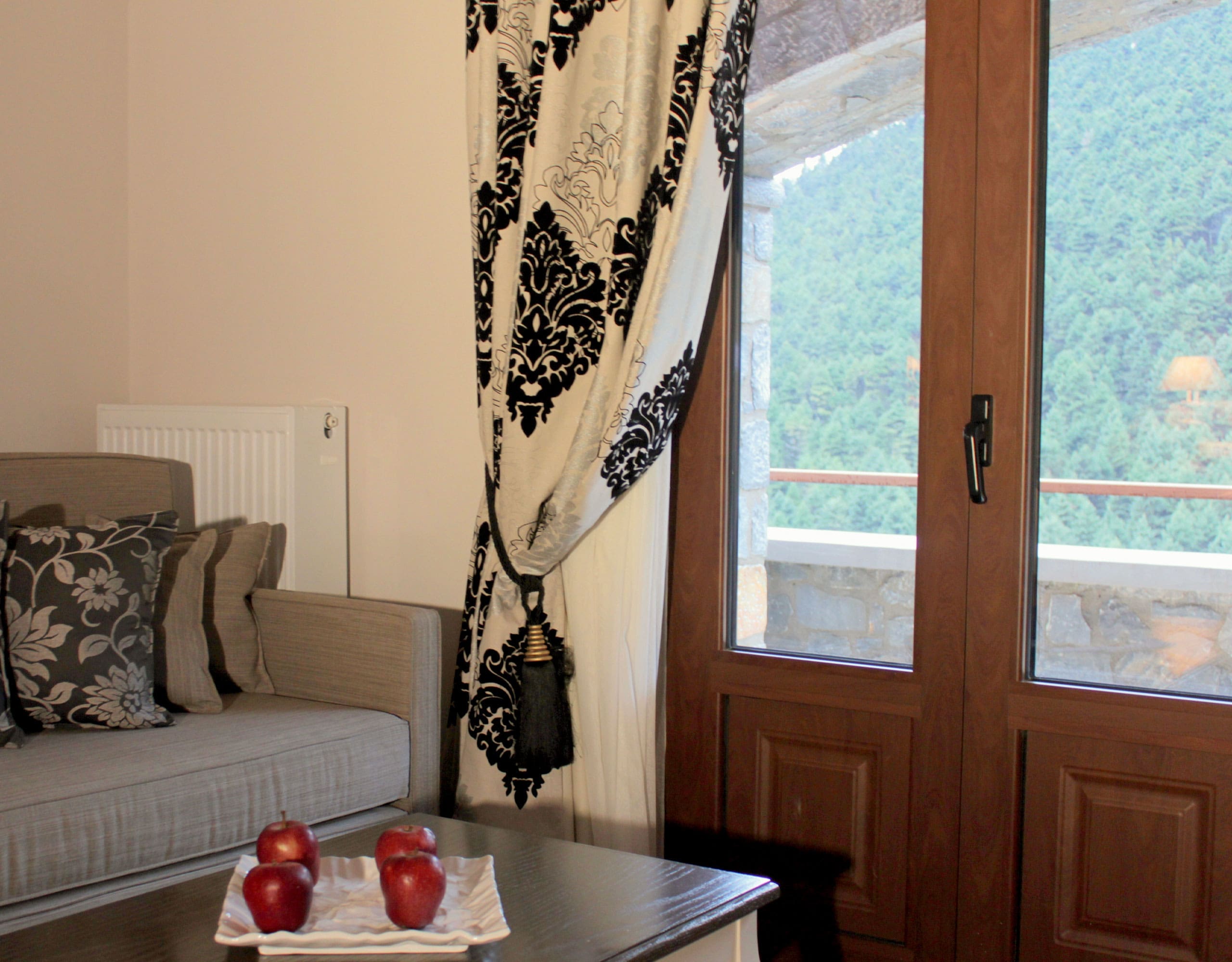 Living room corner with sofa seating and balcony door with mountain view, Kardaras, Mount Mainalo, Arcadia, Greece
