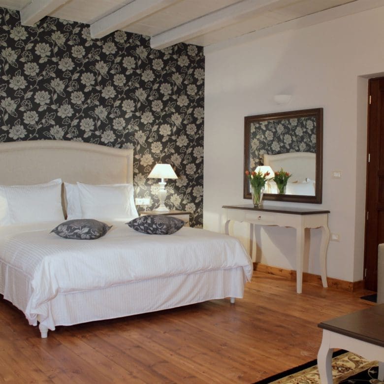 Guest bedroom with double bed, patterned feature wall, and wood flooring, Kardaras, Mount Mainalo, Arcadia, Greece