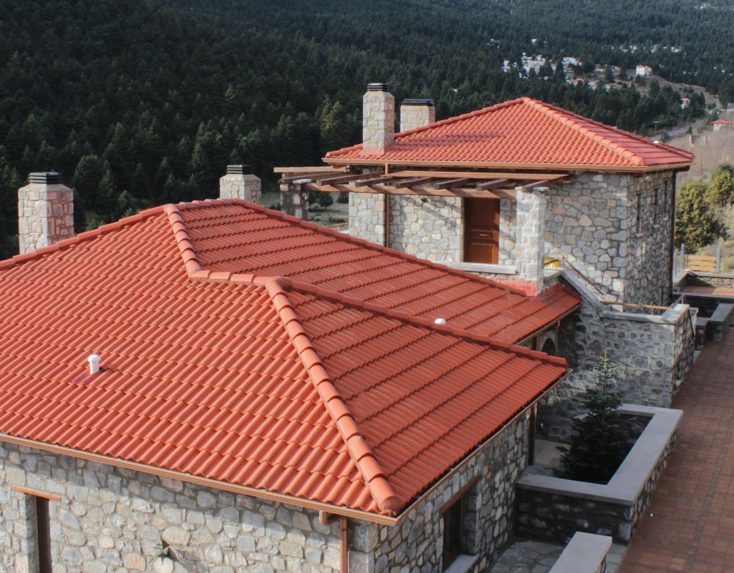 Elevated view over red-tiled rooflines and stone-built volumes, Kardaras, Mount Mainalo, Arcadia, Greece