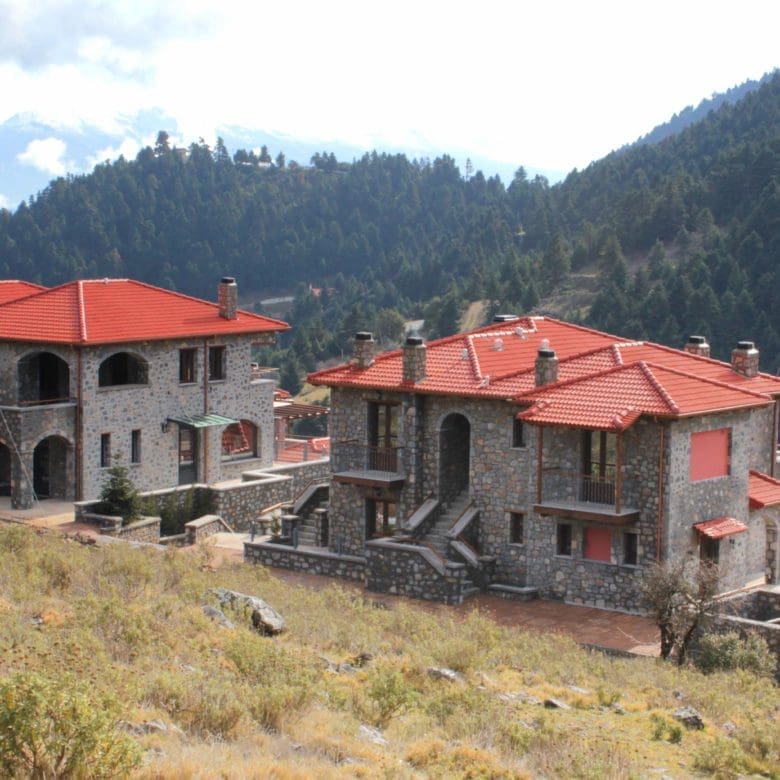 Wide exterior view of the stone-built hotel complex on the mountain slope, Kardaras, Mount Mainalo, Arcadia, Greece