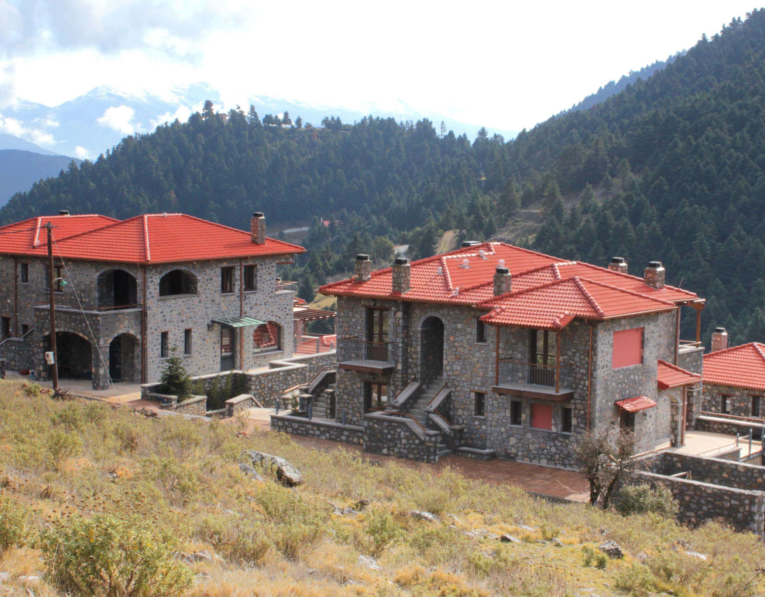 Wide exterior view of the stone-built hotel complex on the mountain slope, Kardaras, Mount Mainalo, Arcadia, Greece
