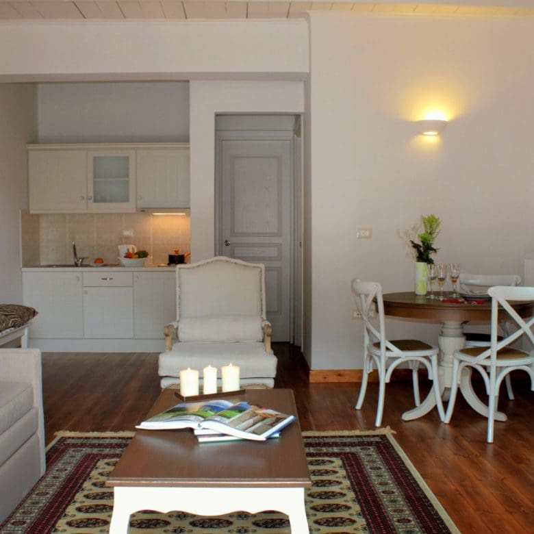 Open-plan suite living area with sofa, dining table, and kitchenette, Kardaras, Mount Mainalo, Arcadia, Greece