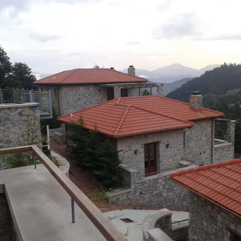 Balcony view over stone rooftops and mountain landscape, Kardaras, Mount Mainalo, Arcadia, Greece