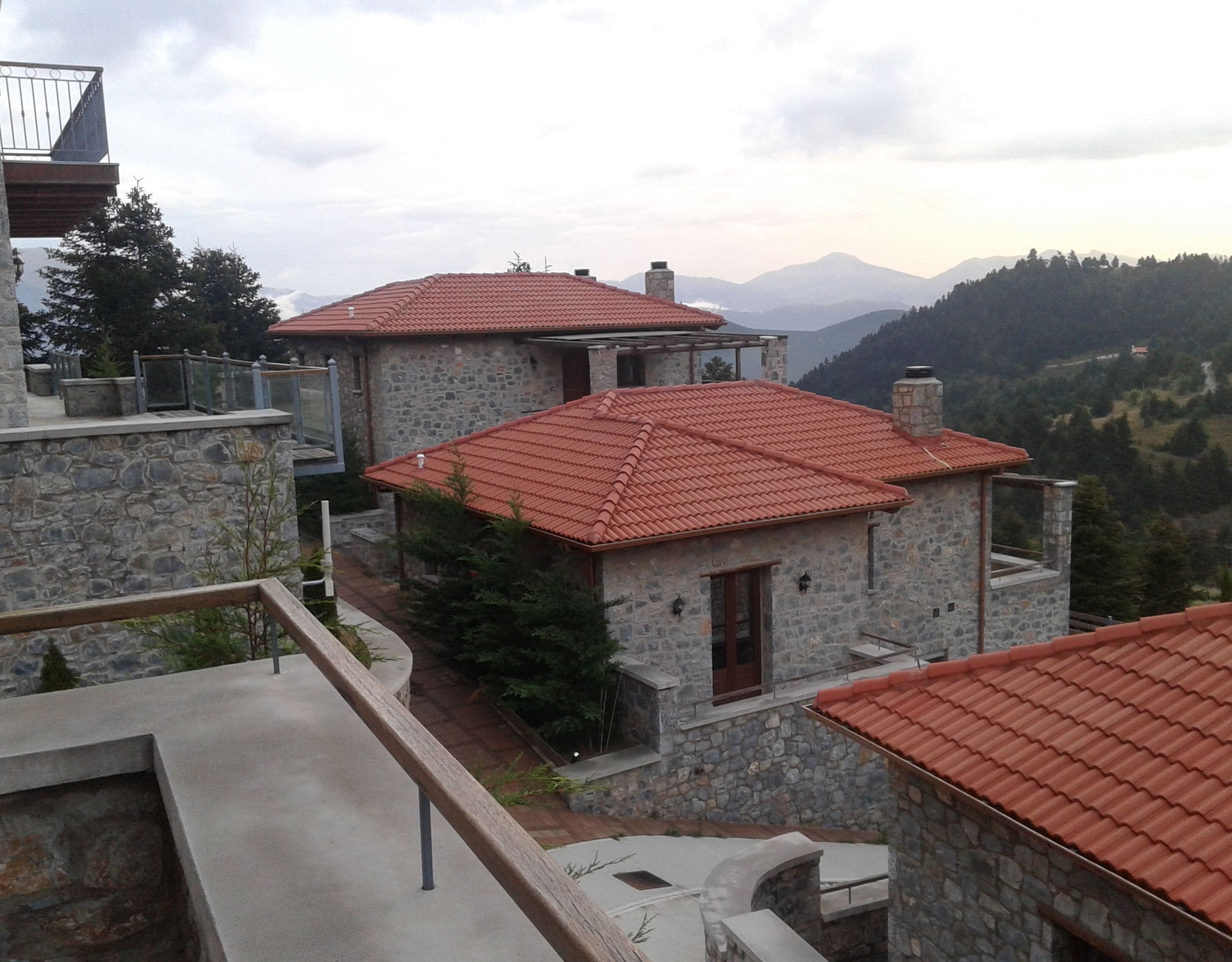 Balcony view over stone rooftops and mountain landscape, Kardaras, Mount Mainalo, Arcadia, Greece