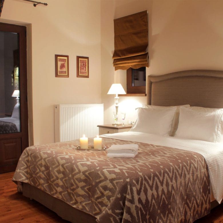 Guest bedroom with double bed, bedside lamps, and warm wood finishes, Kardaras, Mount Mainalo, Arcadia, Greece