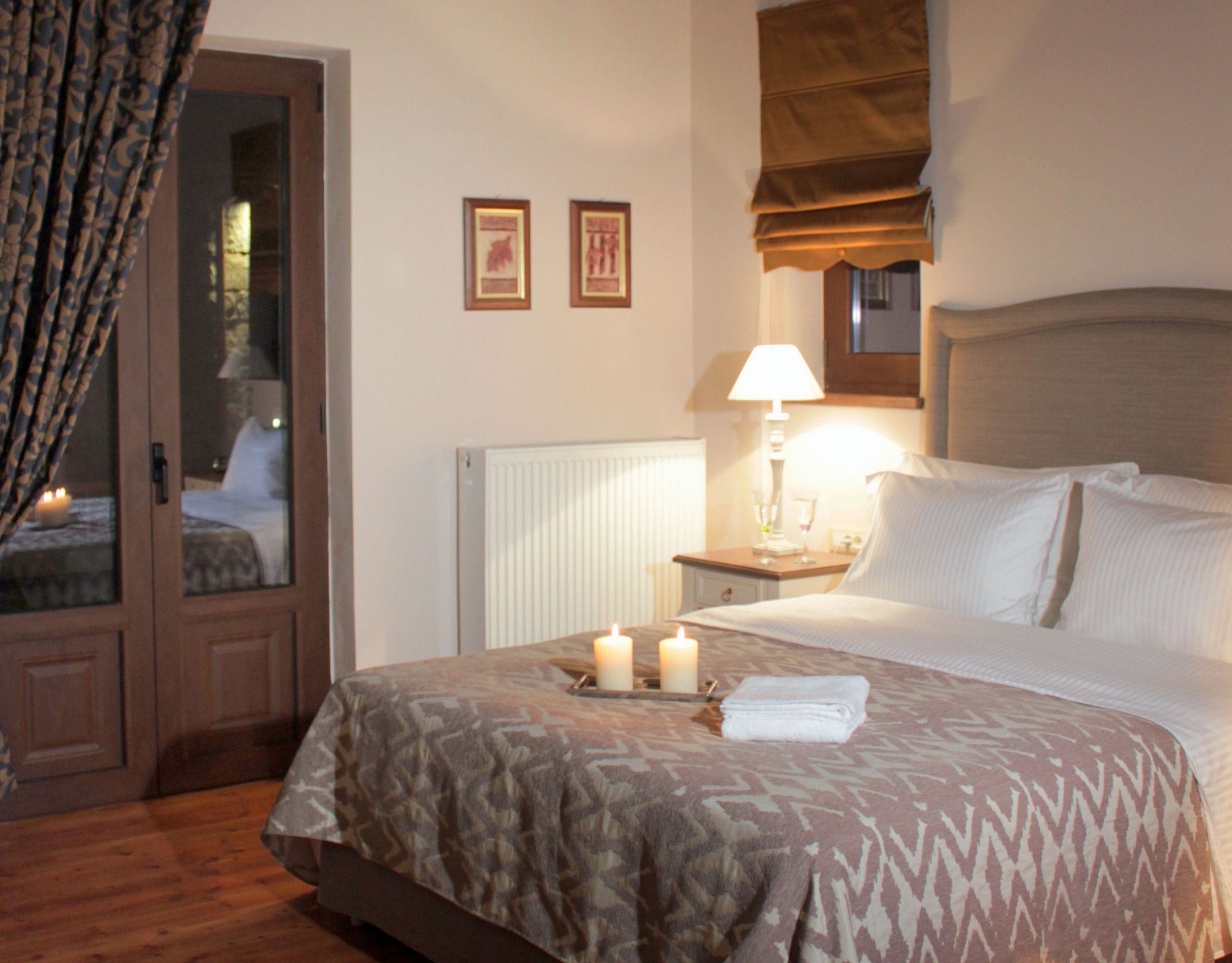 Guest bedroom detail with double bed, bedside lamp, and warm decor, Kardaras, Mount Mainalo, Arcadia, Greece
