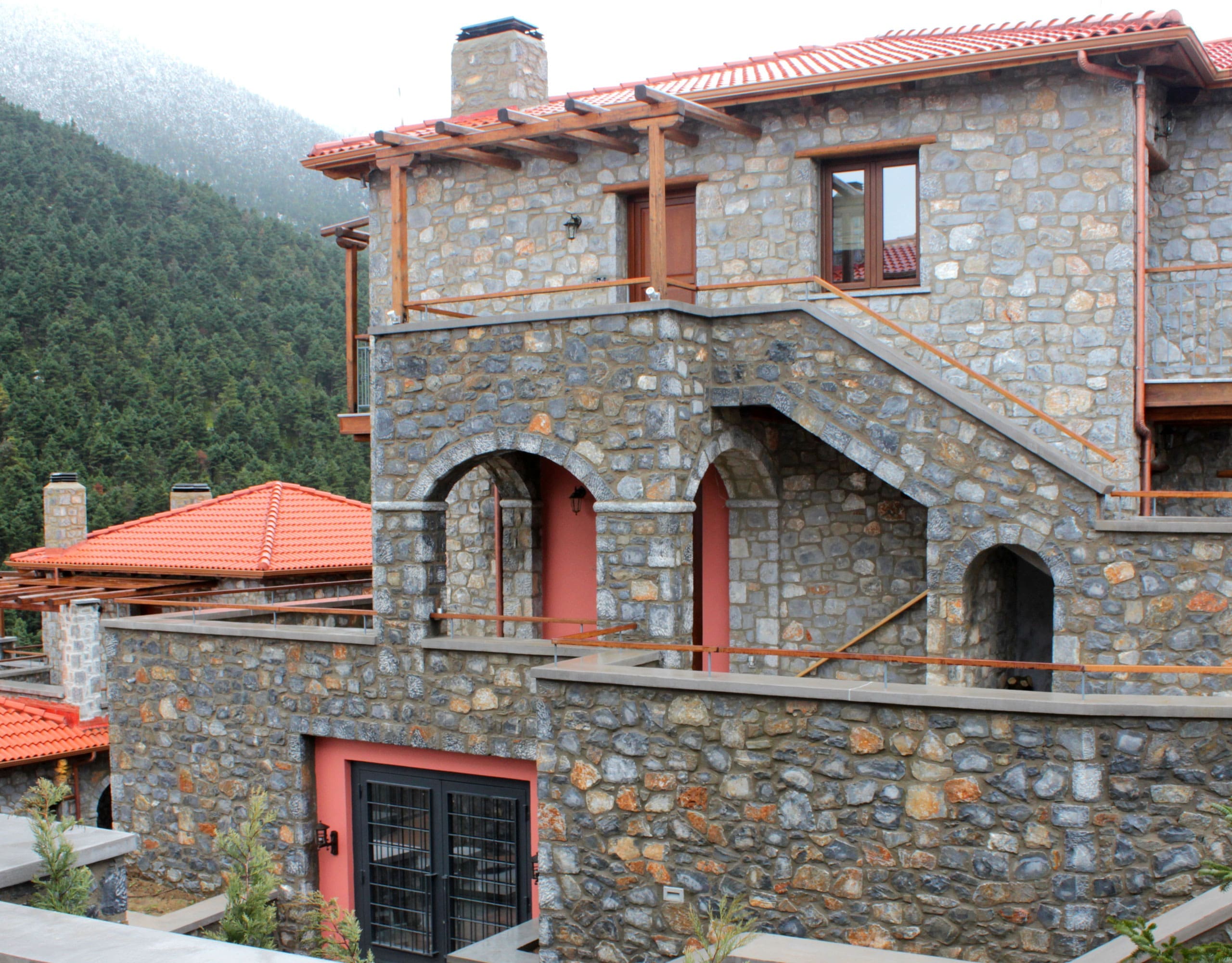 Stone-built hotel exterior with balconies and mountain setting, Kardaras, Mount Mainalo, Arcadia, Greece