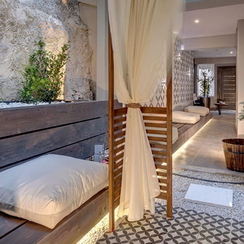 Outdoor courtyard lounge with daybed seating and patterned tile floor, Pasalimani (Zea Marina), Piraeus, Greece