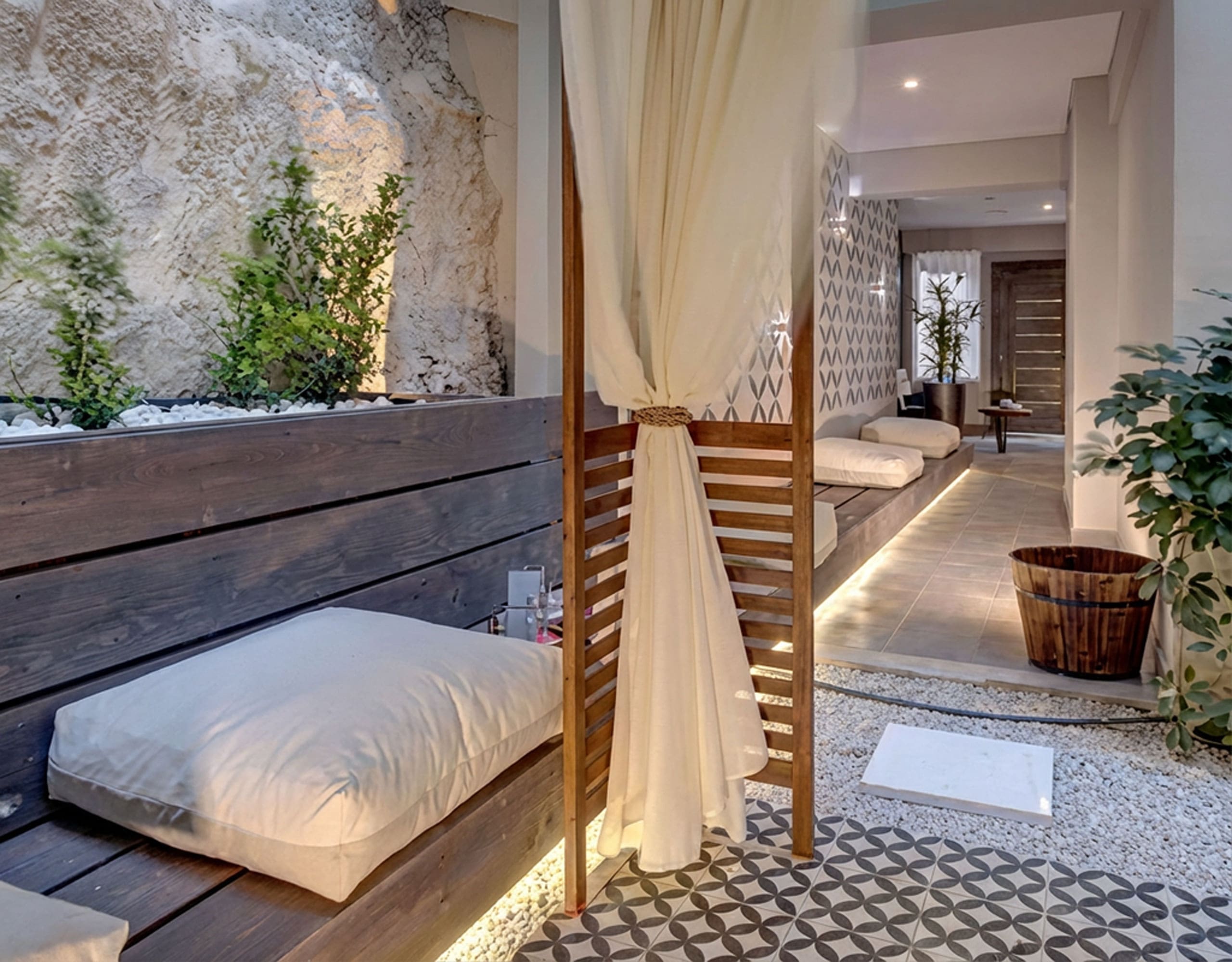 Outdoor courtyard lounge with daybed seating and patterned tile floor, Pasalimani (Zea Marina), Piraeus, Greece