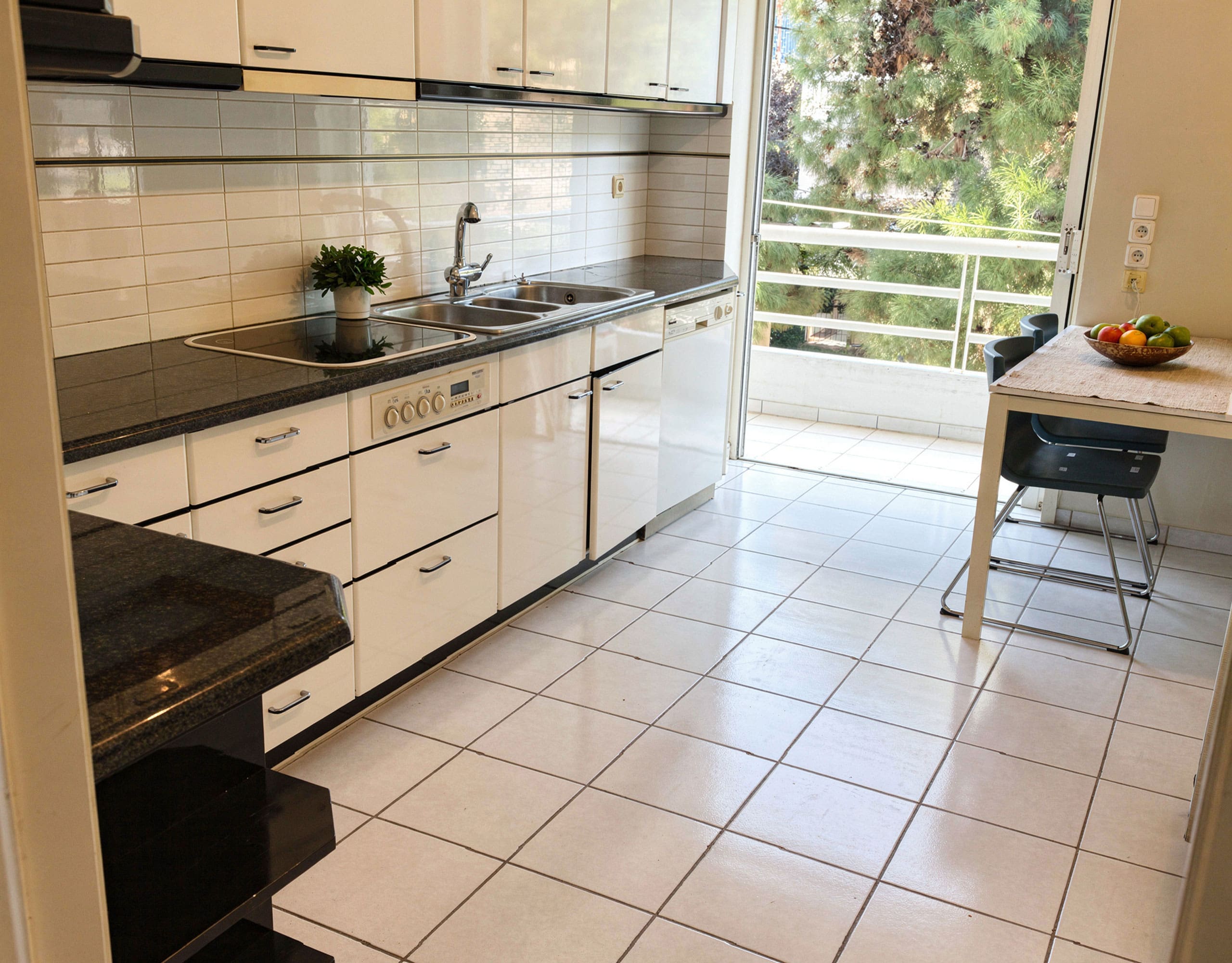 Voula Duplex 181 sqm – Kitchen With White Cabinetry Kitchen with white cabinetry, black countertops, and tiled floor, Voula, Athens Riviera, Greece