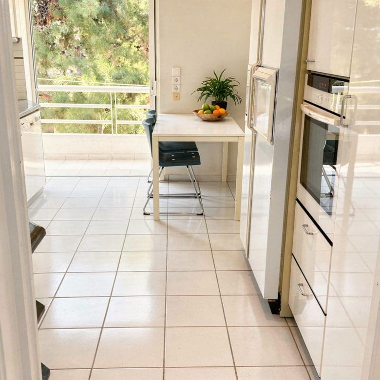 Kitchen with dining nook, built-in oven, and balcony door, Voula, Athens Riviera, Greece