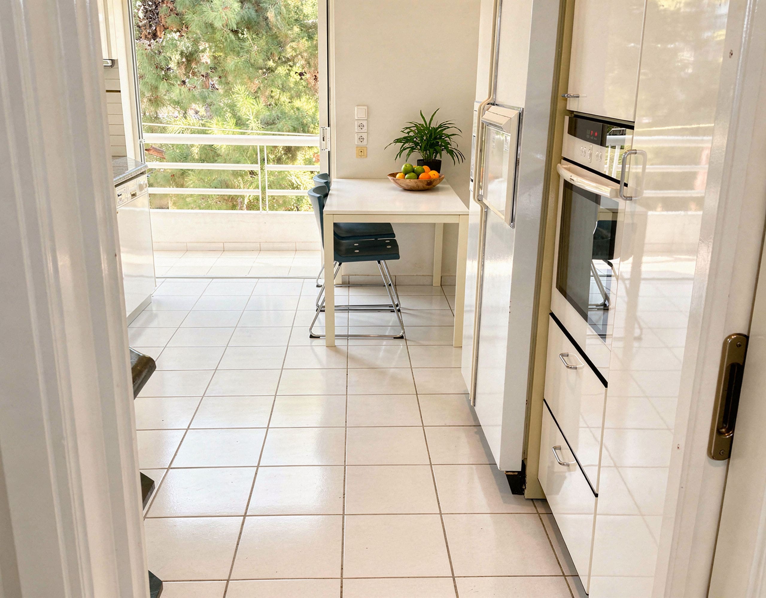 Voula Duplex 181 sqm – Kitchen With Dining Nook Kitchen with dining nook, built-in oven, and balcony door, Voula, Athens Riviera, Greece