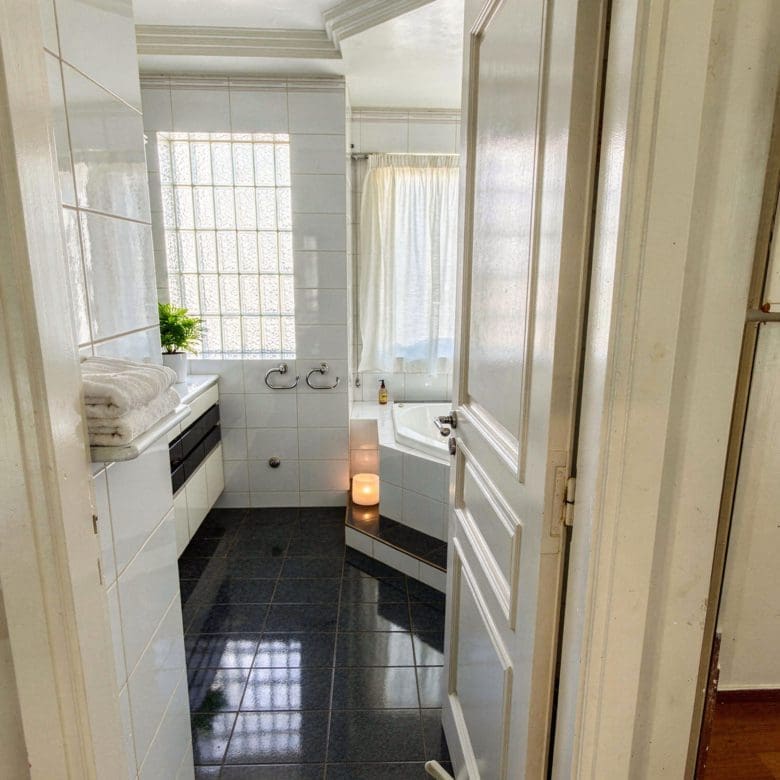 Bathroom view from the doorway with tiled floor and shower area, Voula, Athens Riviera, Greece
