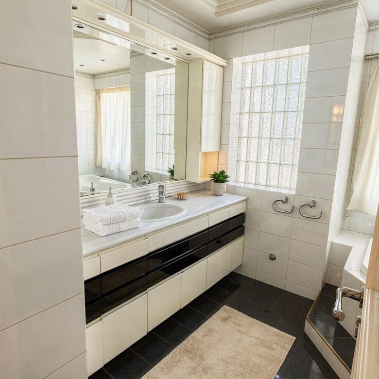 Bathroom with double sink vanity, large mirror, and tiled walls, Voula, Athens Riviera, Greece