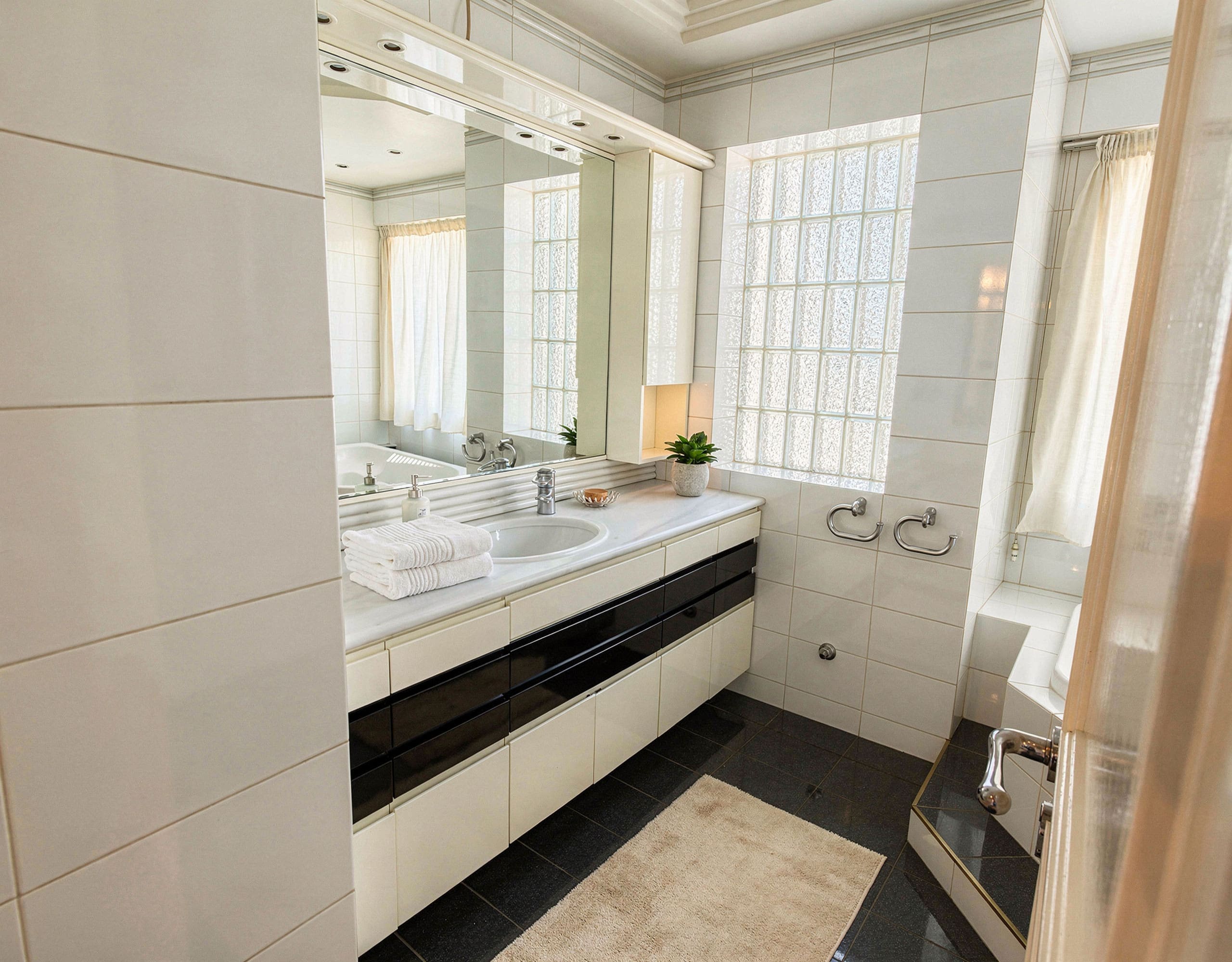 Voula Duplex 181 sqm – Bathroom With Double Vanity Bathroom with double sink vanity, large mirror, and tiled walls, Voula, Athens Riviera, Greece