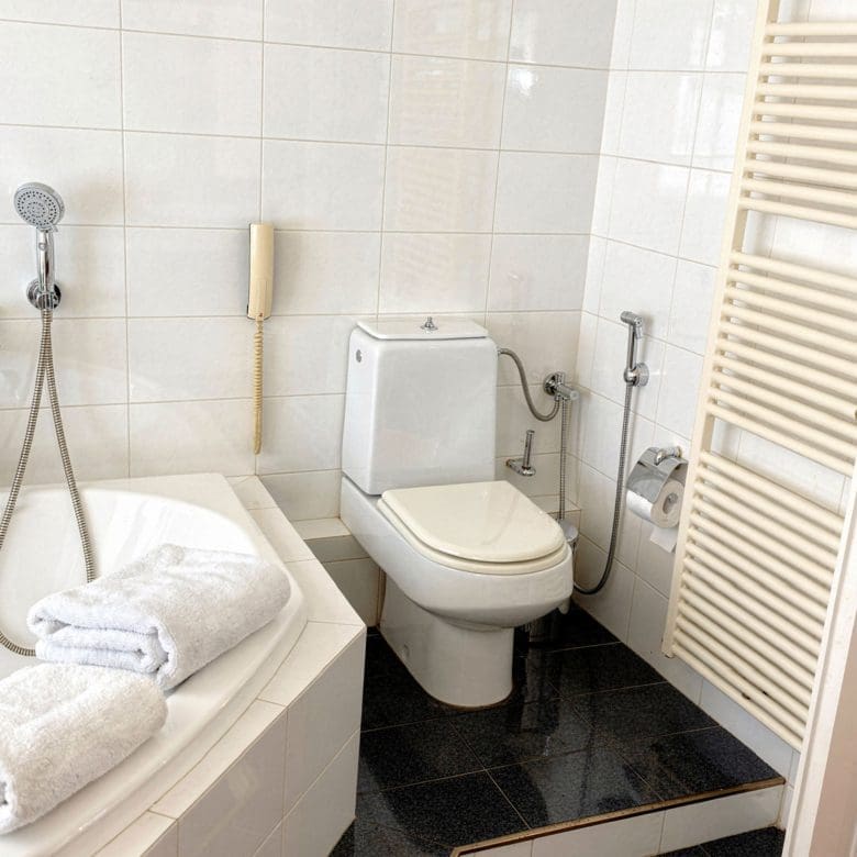 Bathroom with bathtub, toilet, and tiled walls, Voula, Athens Riviera, Greece