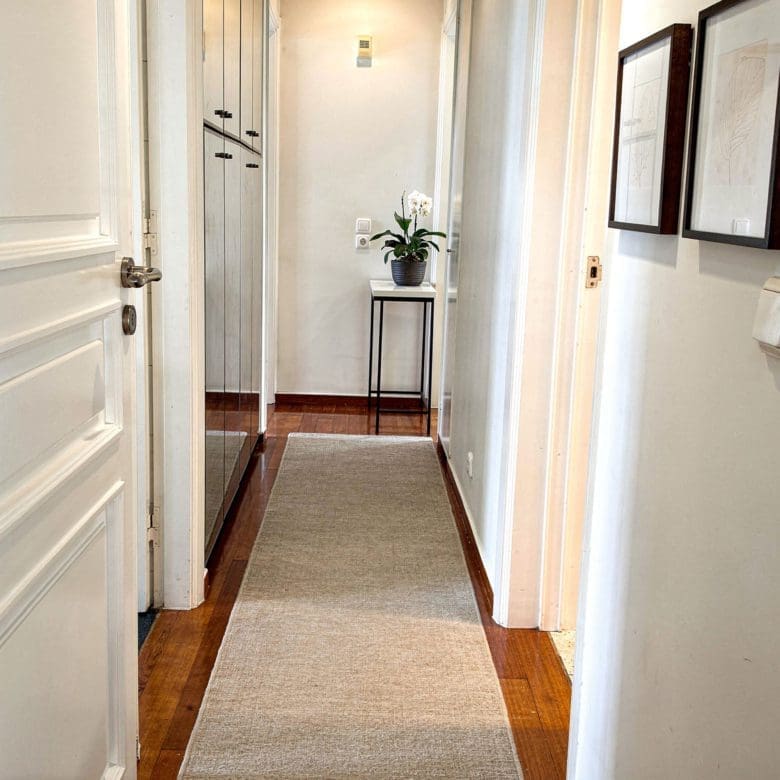 Interior corridor with white walls, framed art, and wood flooring, Voula, Athens Riviera, Greece