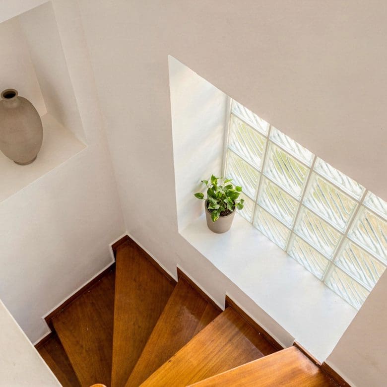 Staircase with wooden steps and window bringing in natural light, Voula, Athens Riviera, Greece