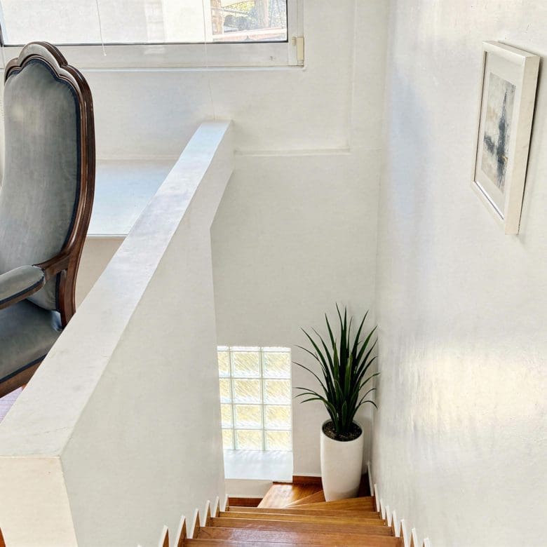 Upper landing with railing, wood flooring, and bright window, Voula, Athens Riviera, Greece