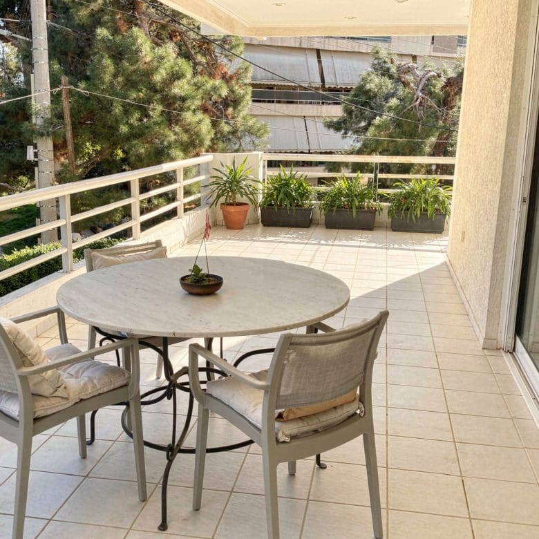Balcony dining area with round table and chairs, Voula, Athens Riviera, Greece
