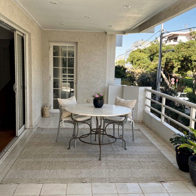 Covered balcony with outdoor table, tiled floor, and seating by the facade, Voula, Athens Riviera, Greece