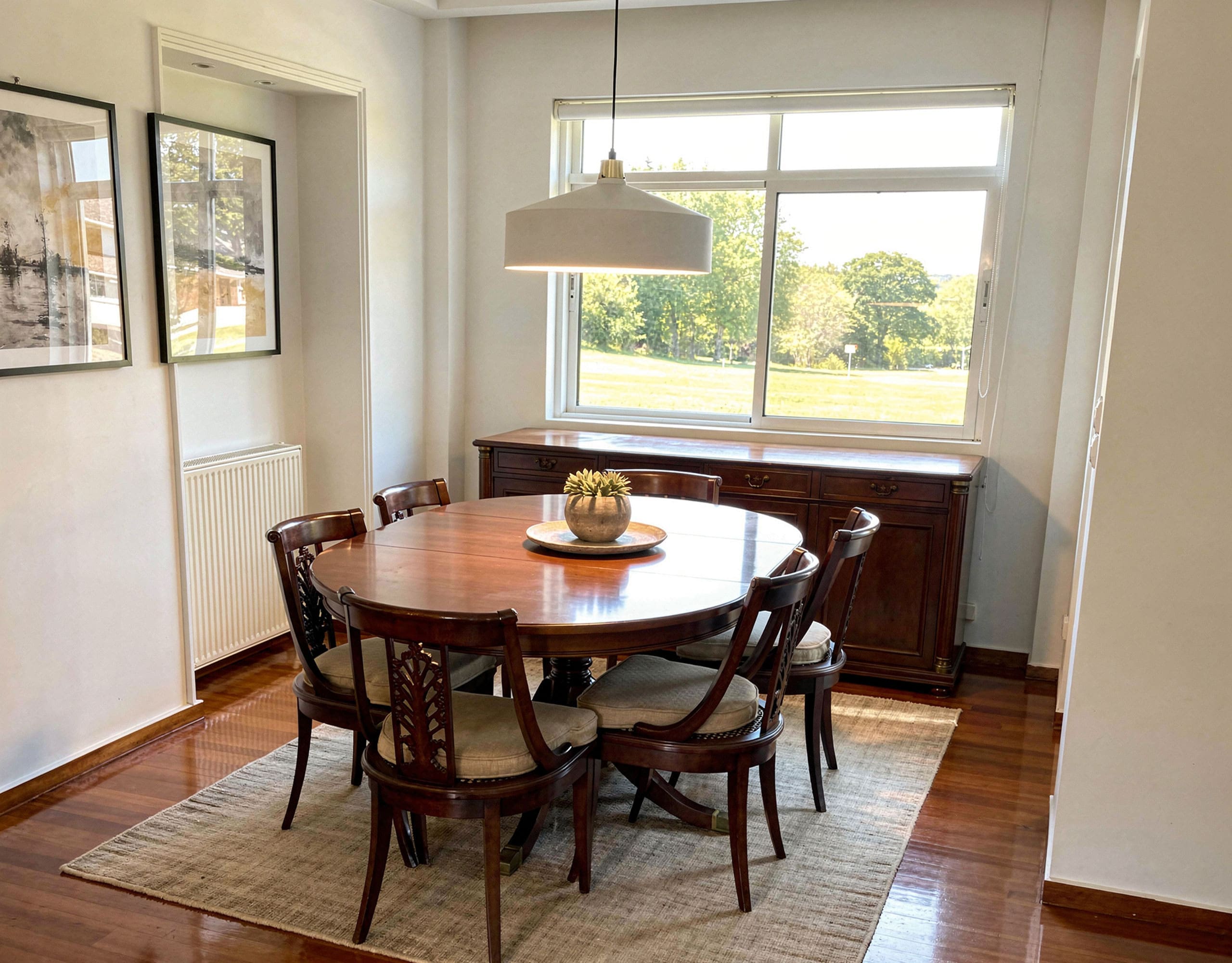 Voula Duplex 181 sqm – Dining Area With Large Window Dining area with round table, pendant light, and large window, Voula, Athens Riviera, Greece