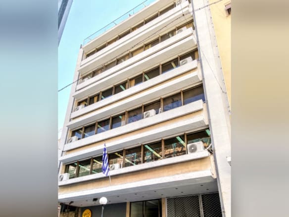 Exterior view of a multi-storey building facade with balconies, Piraeus, Greece