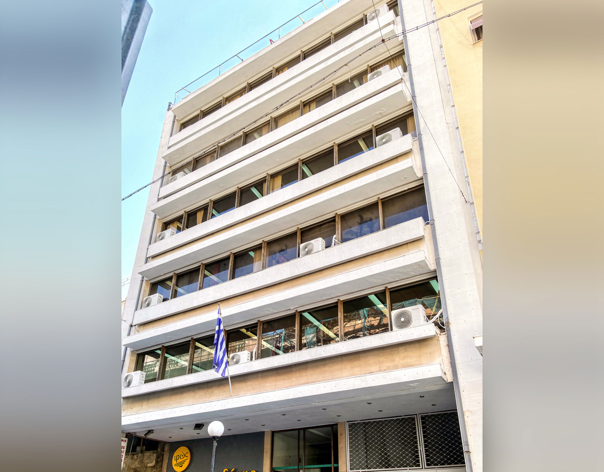 Exterior view of a multi-storey building facade with balconies, Piraeus, Greece