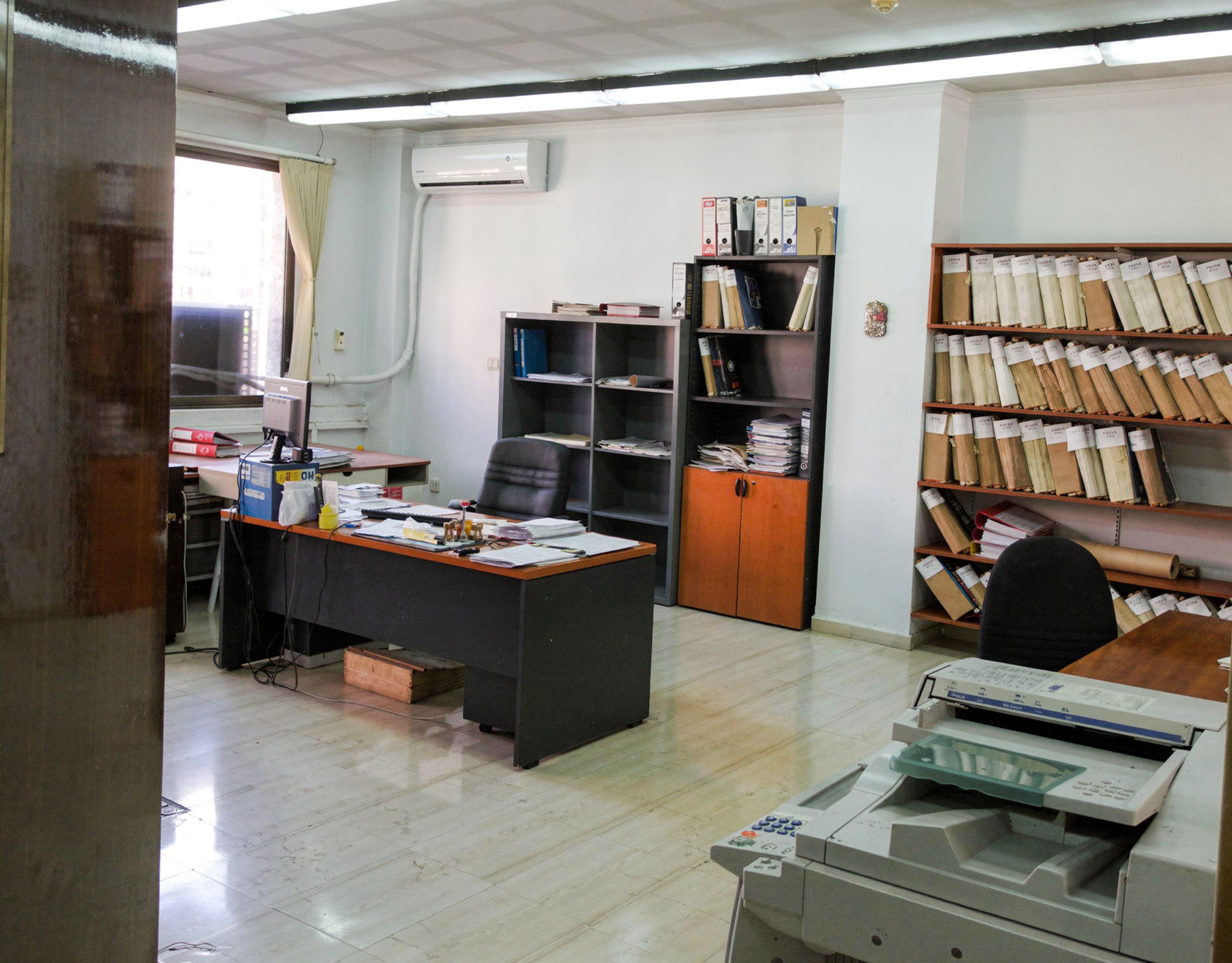 Office interior with desk, shelving, and document storage, Piraeus, Greece