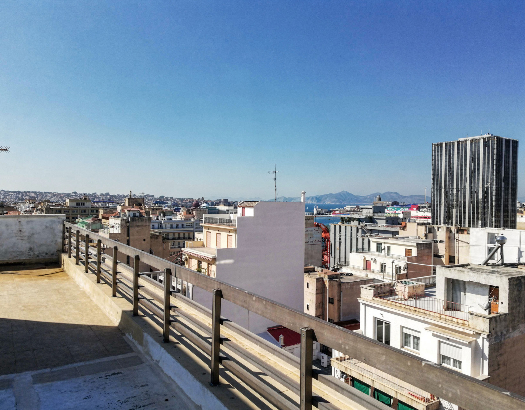 Rooftop view over the city with surrounding buildings and distant hills, Piraeus, Greece