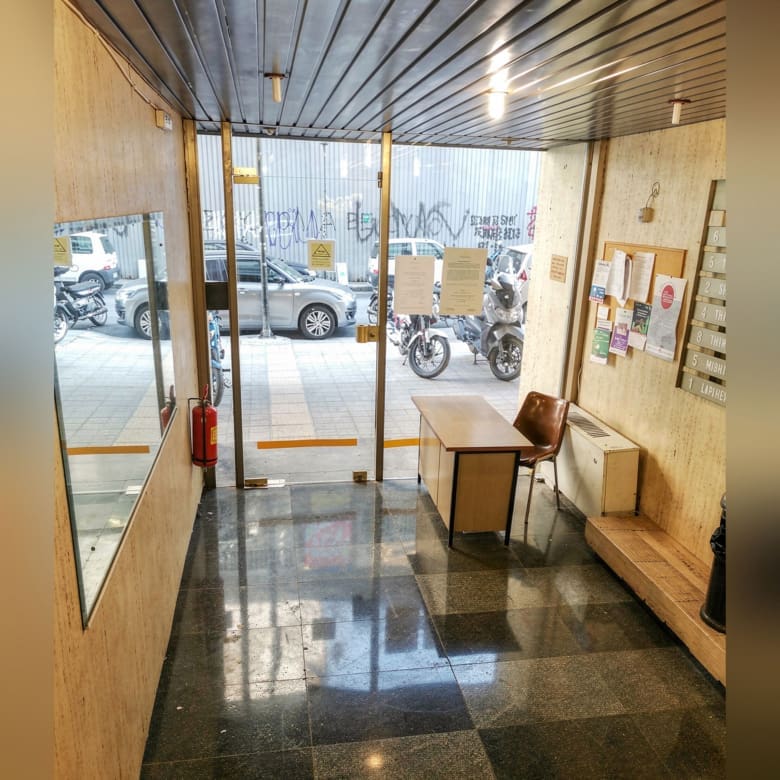 Rooftop access corridor with glass doors and city light, Piraeus, Greece