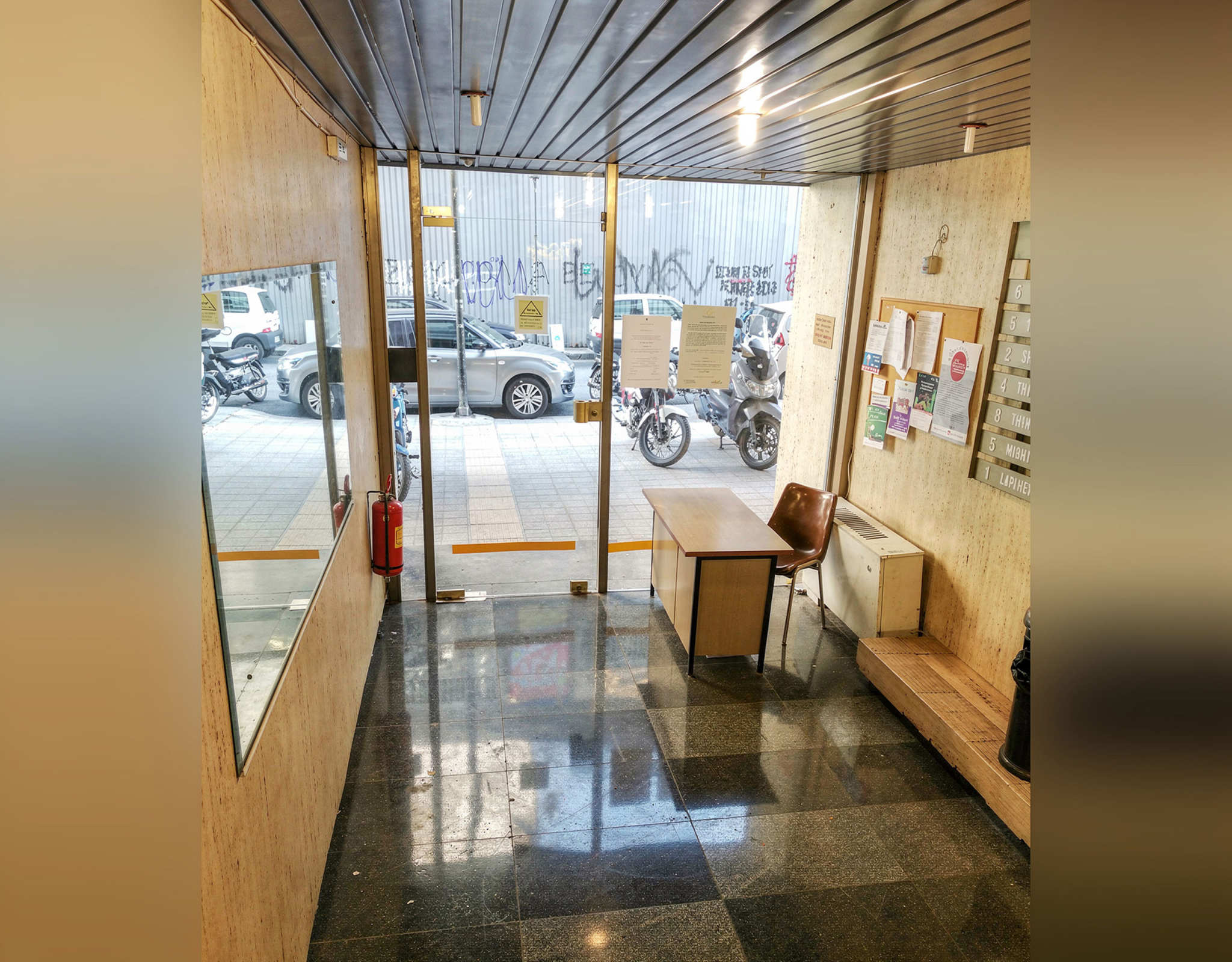 Rooftop access corridor with glass doors and city light, Piraeus, Greece