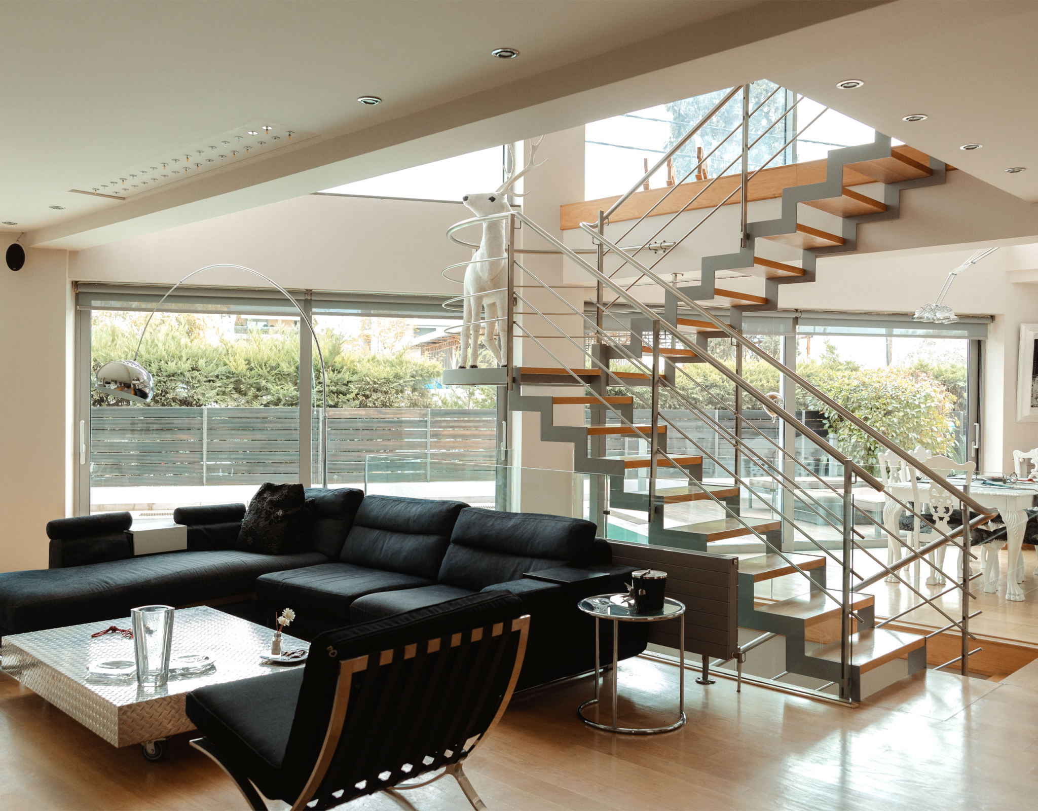 Contemporary living room with open layout and staircase at a private villa in Alimos, Athens Riviera