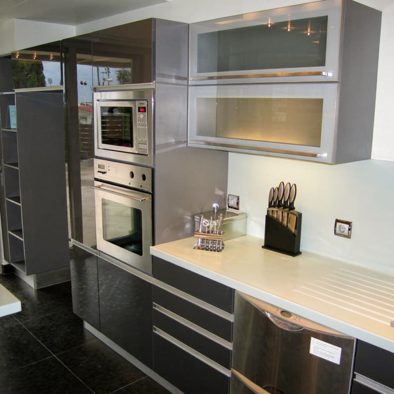 Modern kitchen with built-in appliances and sleek cabinetry at a private villa in Alimos, Athens Riviera