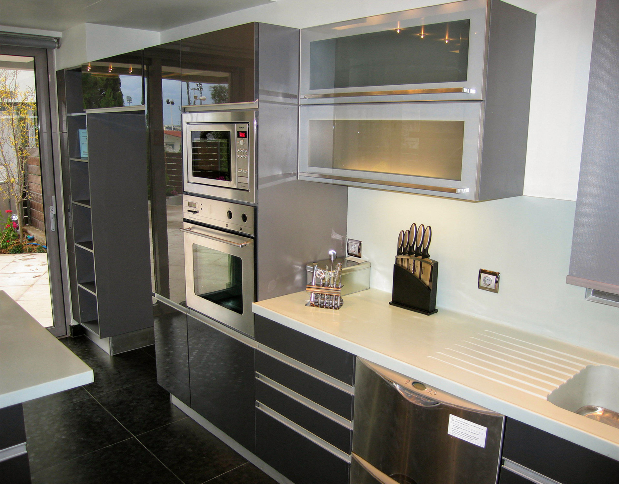 Modern kitchen with built-in appliances and sleek cabinetry at a private villa in Alimos, Athens Riviera