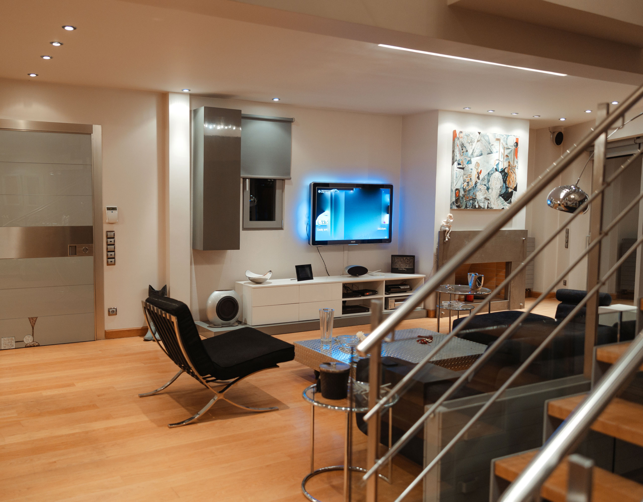 Lounge and TV area with staircase connection at a private villa in Alimos, Athens Riviera