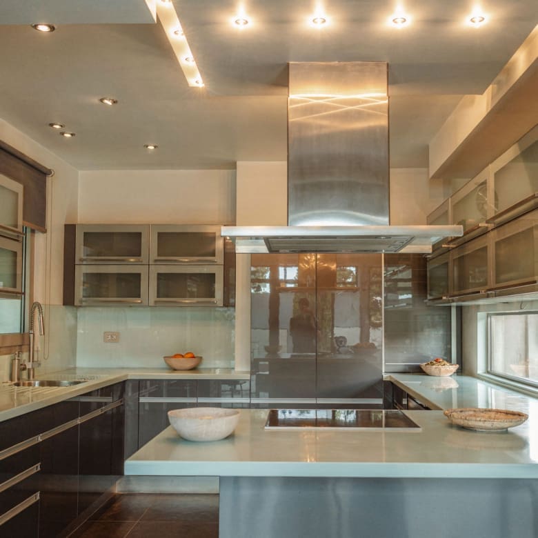 Kitchen cooking zone with range hood and modern finishes at a private villa in Alimos, Athens Riviera