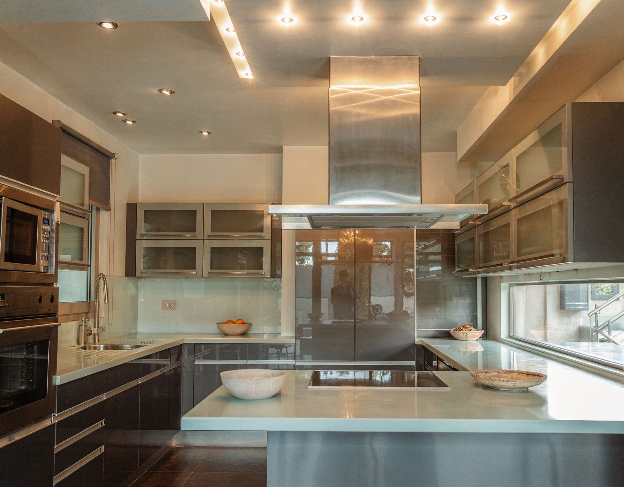 Kitchen cooking zone with range hood and modern finishes at a private villa in Alimos, Athens Riviera