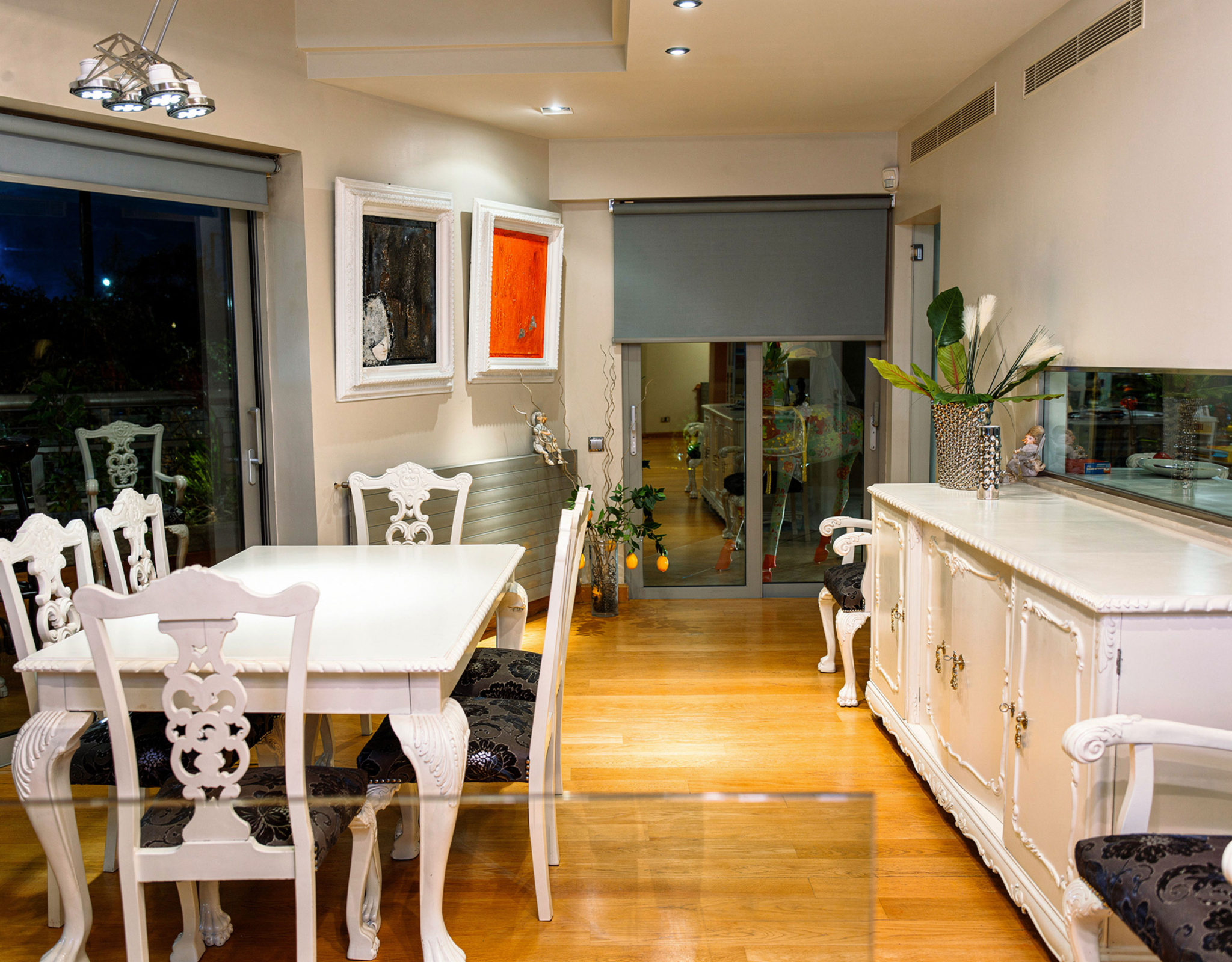 Open-plan kitchen and dining area with sliding doors at a private villa in Alimos, Athens Riviera