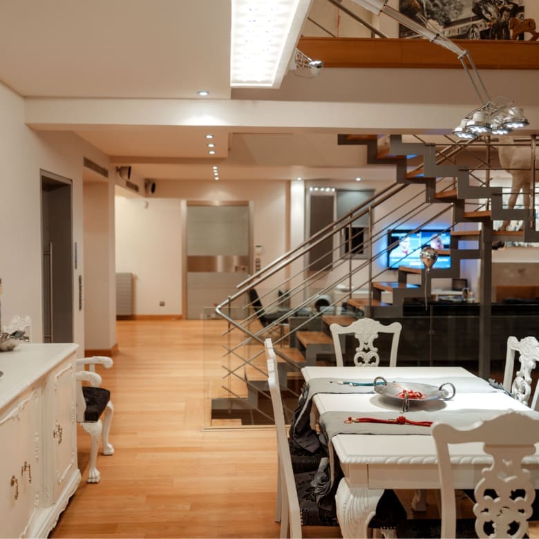 Open-plan kitchen with dining area and modern finishes at a private villa in Alimos, Athens Riviera